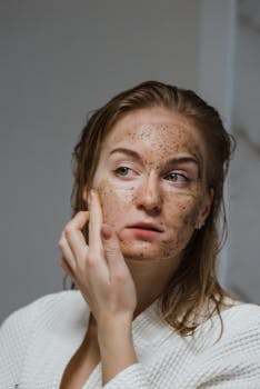 Skincare Self-Care Moment Young woman in a bathrobe applying a natural face pack